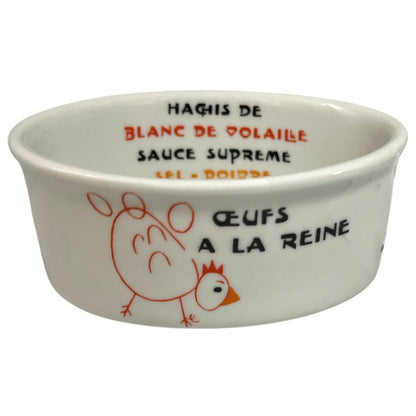 White ceramic ramekin with chicken illustration and text on a white background