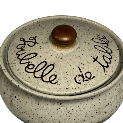 French vintage ceramic beige and brown speckled table bin with “Poubelle de Table” inscribed on the front, featuring a lid, perfect for a country cottage or for outdoor dining at a BBQ, displayed against a white background.
