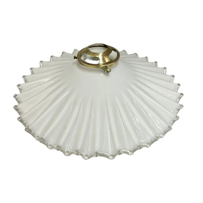 White scalloped-edge glass lampshade with brass fitting on a white background, for a period living room styling or vintage home decor 