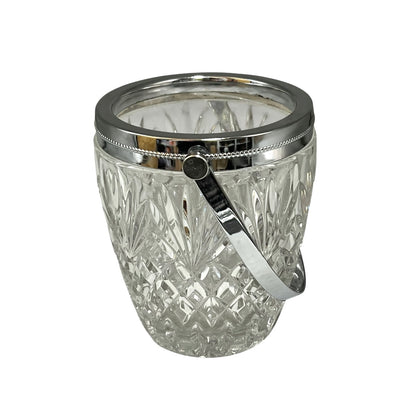 Crystal glass ice bucket with silver rim on a white background