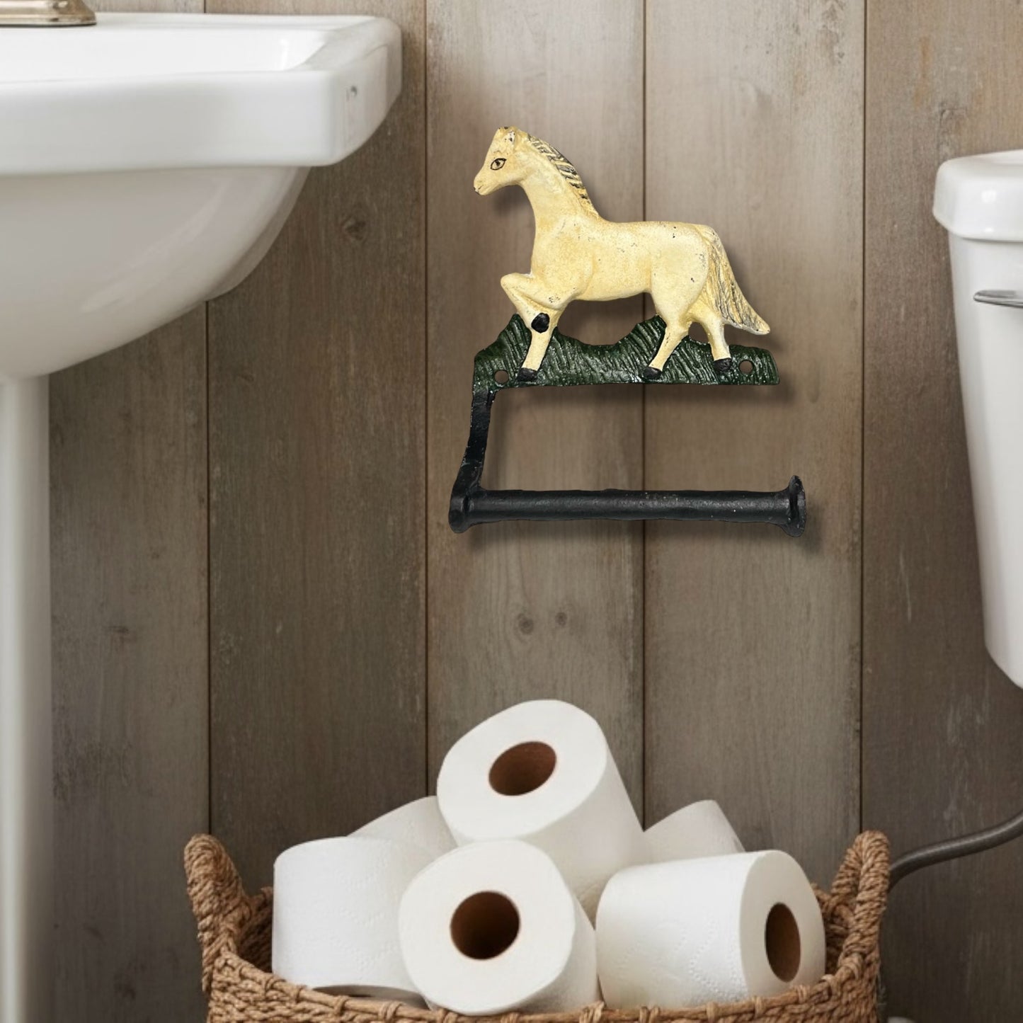 Decorative cast iron horse shaped wall mounted toilet roll holder on a light brown wall in a bathroom