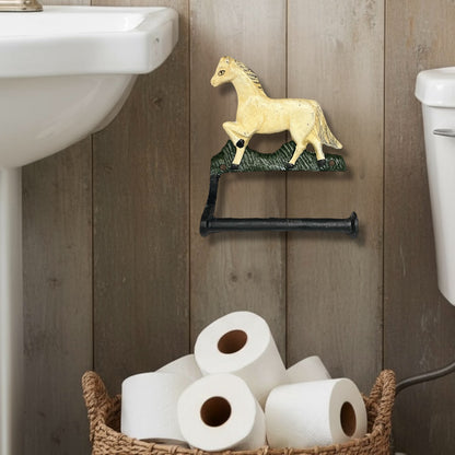 Decorative cast iron horse shaped wall mounted toilet roll holder on a light brown wall in a bathroom