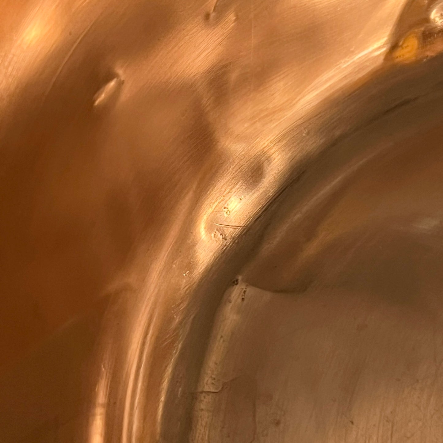 Close up of a French copper bathroom basin on a white background