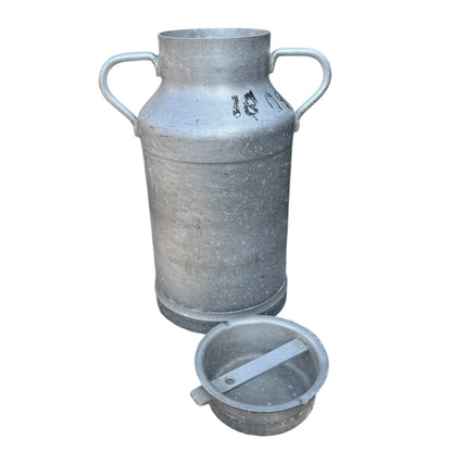 Vintage French aluminium milk churn with a lid on a white background