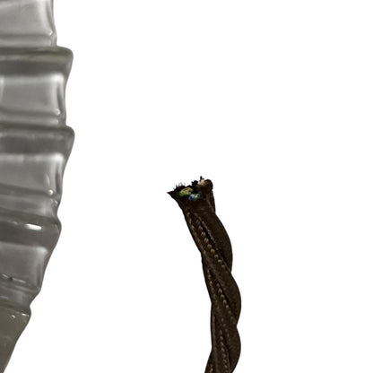 A close-up of a dark brown braided cable or rope with a frayed, exposed inner core, shown against a solid white background.