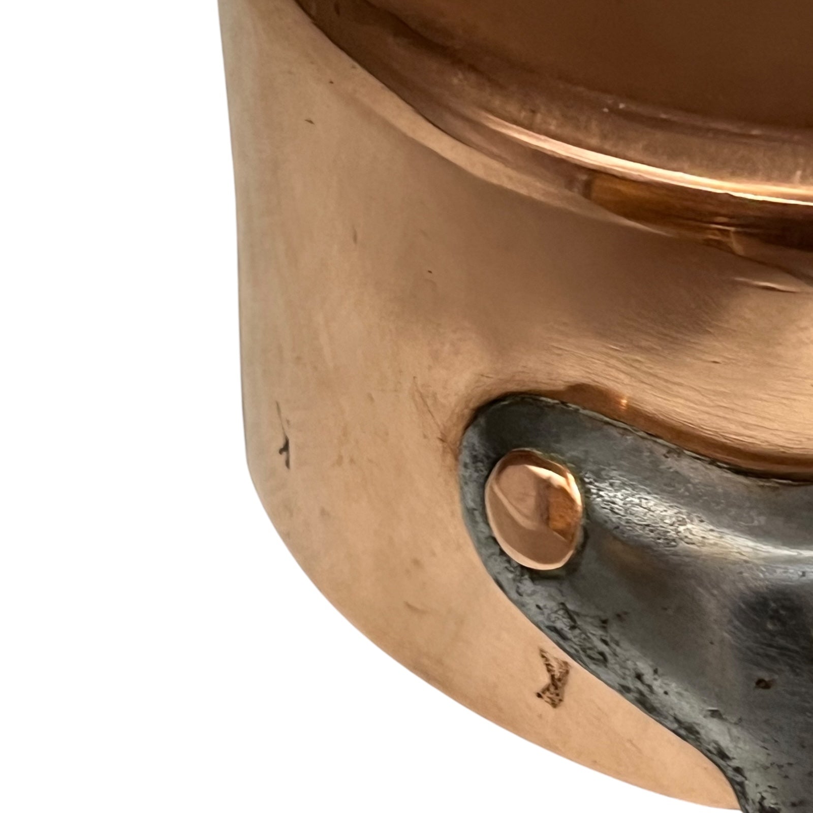 cast iron handle and copper rivets of copper pan