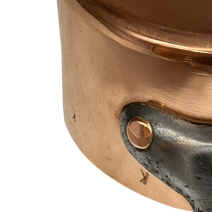 cast iron handle and copper rivets of copper pan