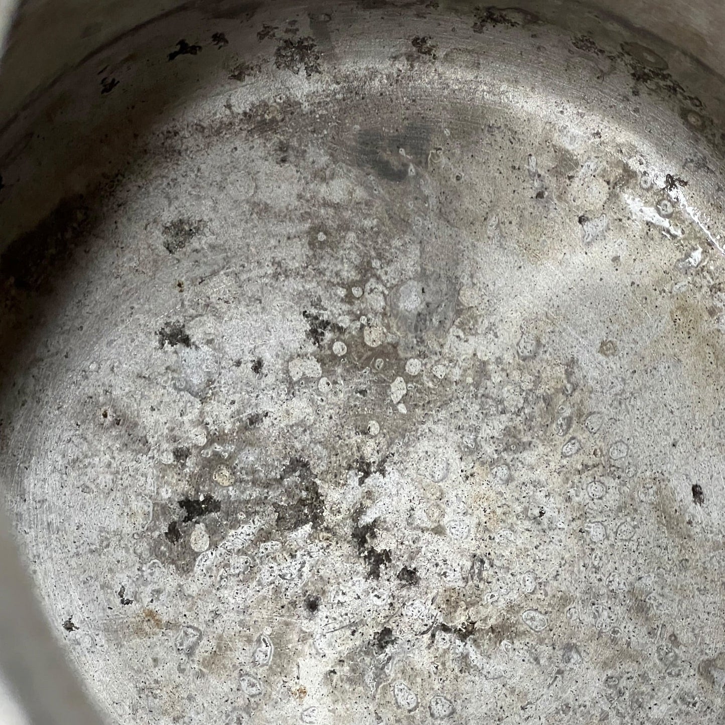 Close up of a vintage metal milk churn on a white background