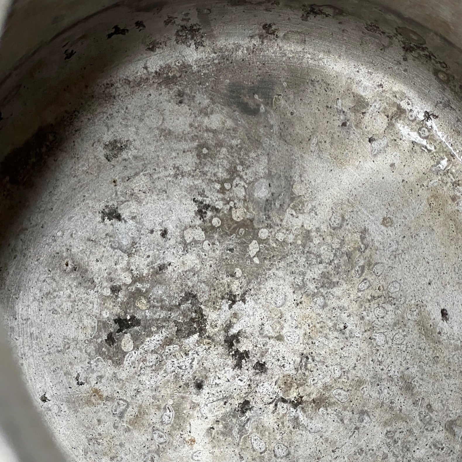 Close up of a vintage metal milk churn on a white background