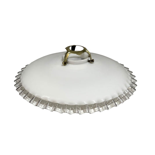 Vintage-style light fixture with white glass shade and brass fitting on a white background