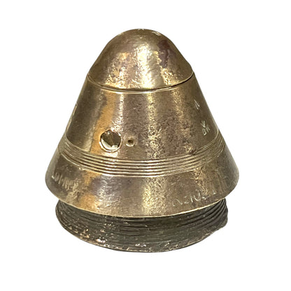 WW1 brass fuse paperweight on a white background