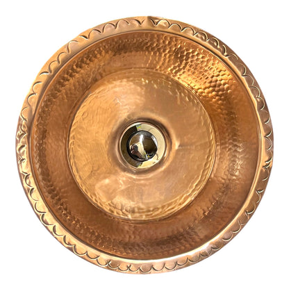Copper sink with textured design on a white background