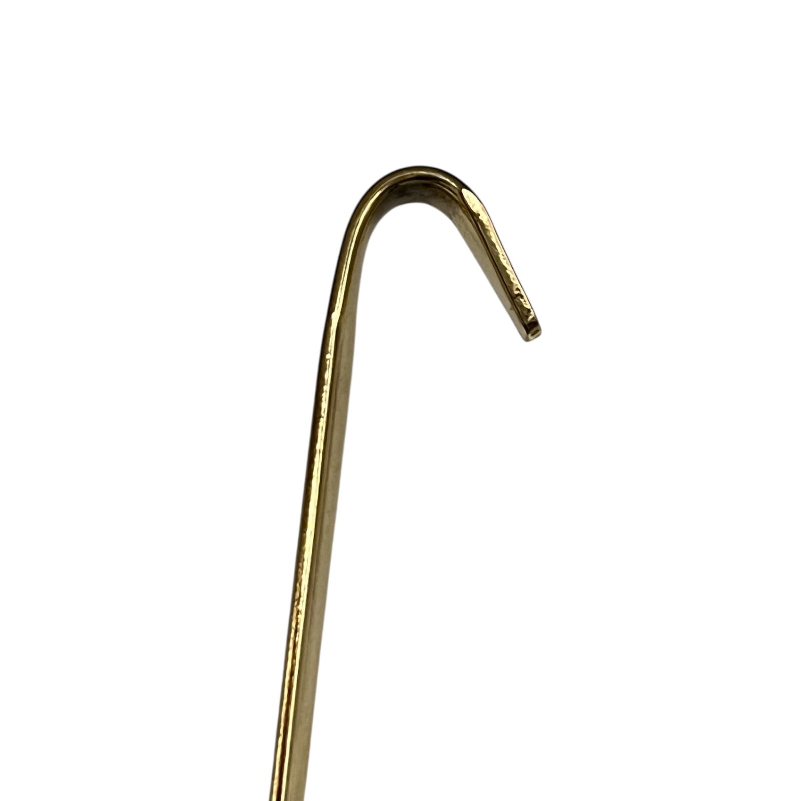 Brass spoon handle on a white background