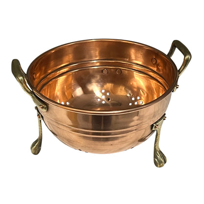 Copper colander with handles on a white background