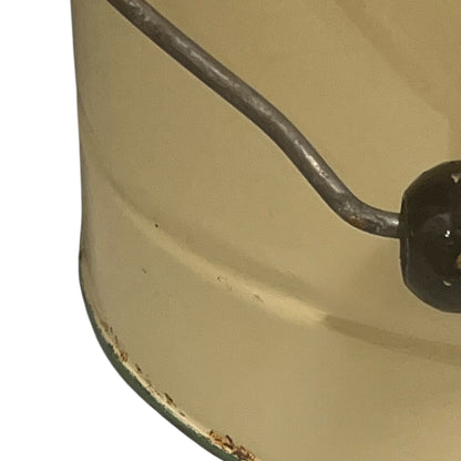 Close up of French vintage cream and green enamel bucket with a lid and handle on a white background