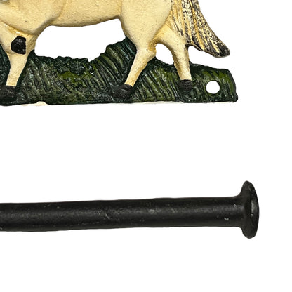Decorative toilet paper holder with a horse design on a white background