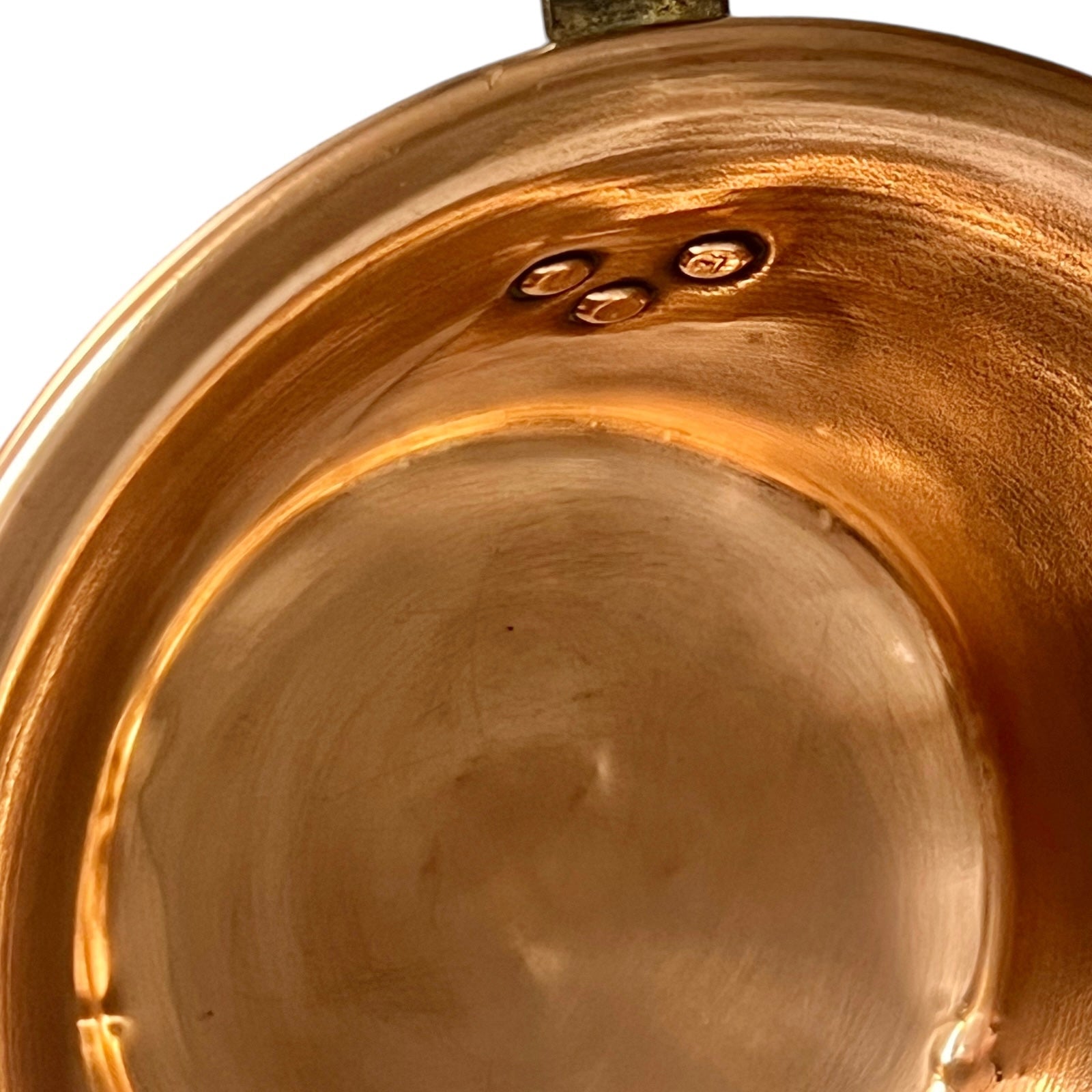 Close up of French vintage copper ladle pan with a black handle on a white background