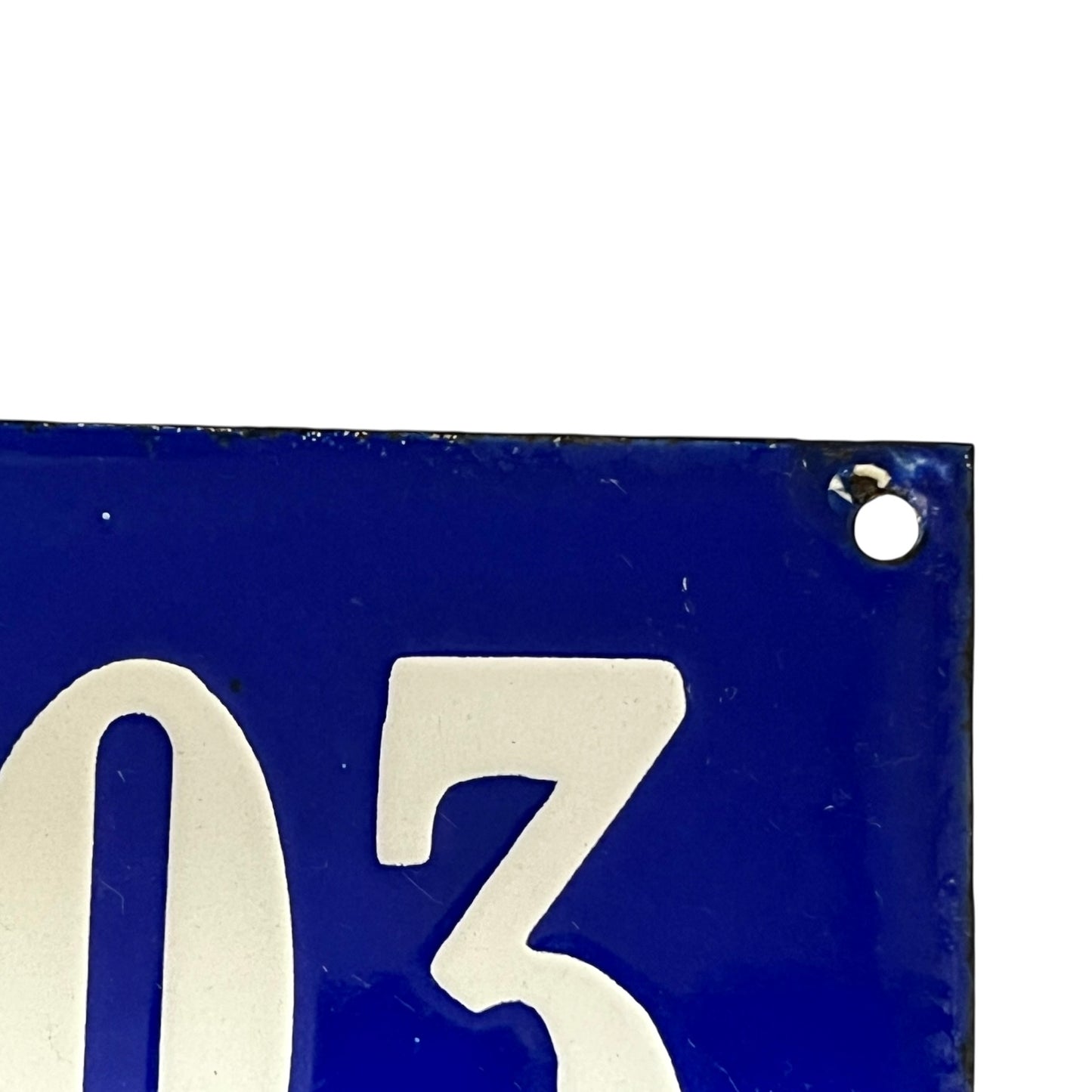 Blue sign with white number '03' on a white background