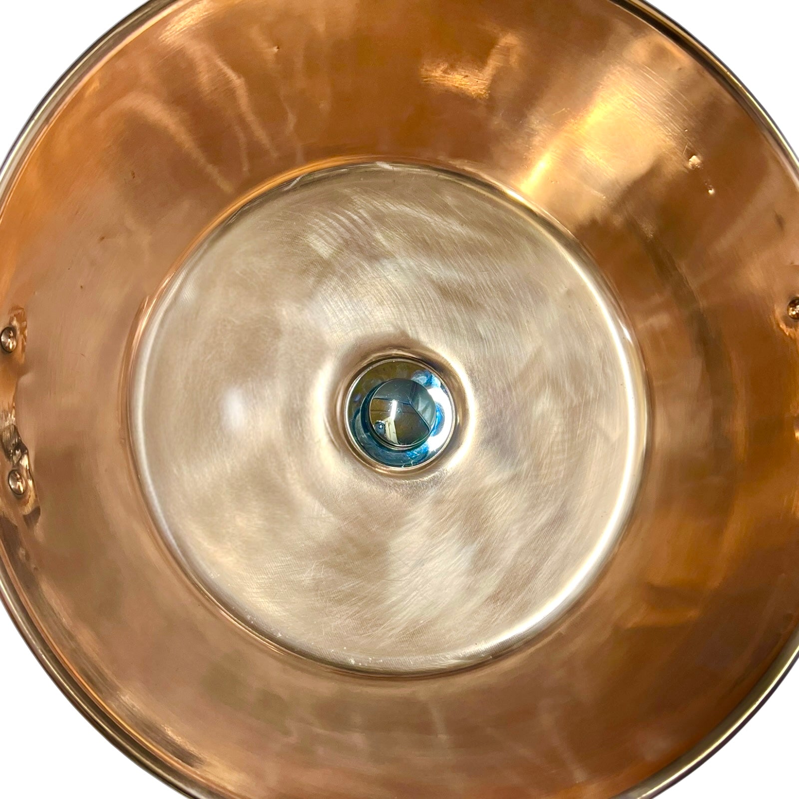 Close-up of a copper basin with a reflective finish on a white background 