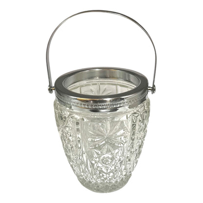 Decorative glass vintage ice bucket with metal collar and handle on a white background