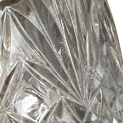 Close up of a French vintage glass ice bucket with silver rim on a white background