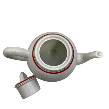 White ceramic teapot with a lid on a white background