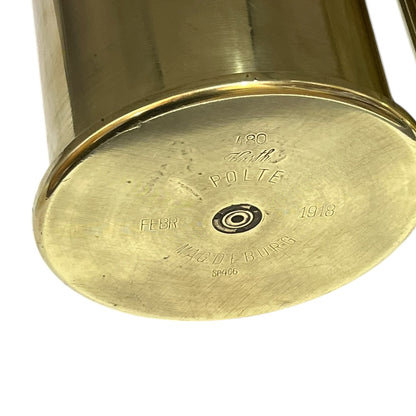 Close up of a brass WW1 German shell case on a white background