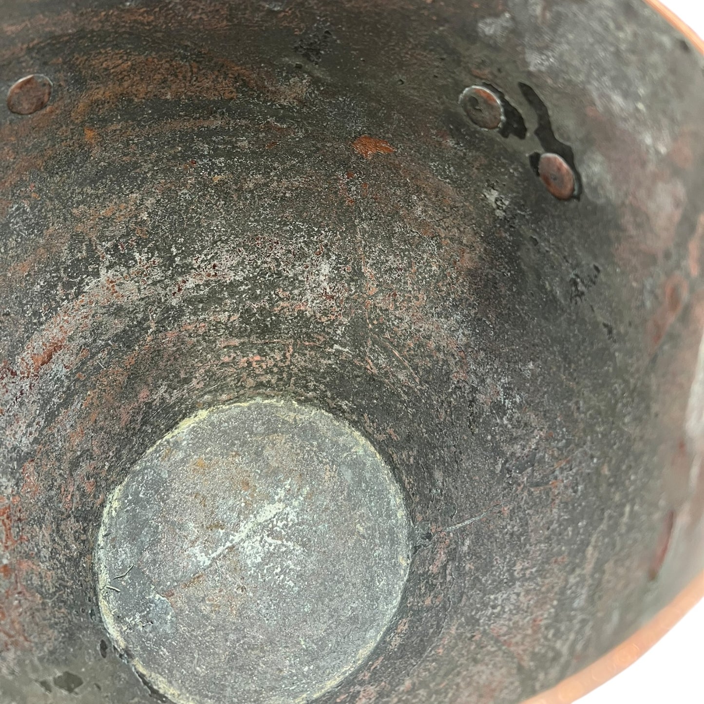 Inside of a copper cooking pot stockpot with handles on a white background