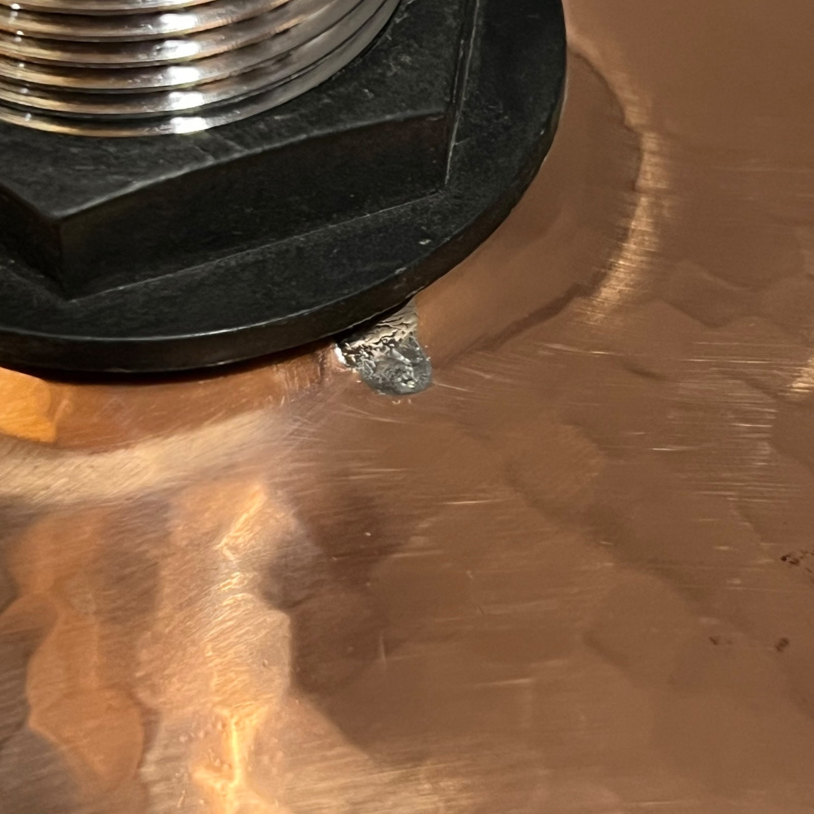 Close-up of a metal object on a reflective surface