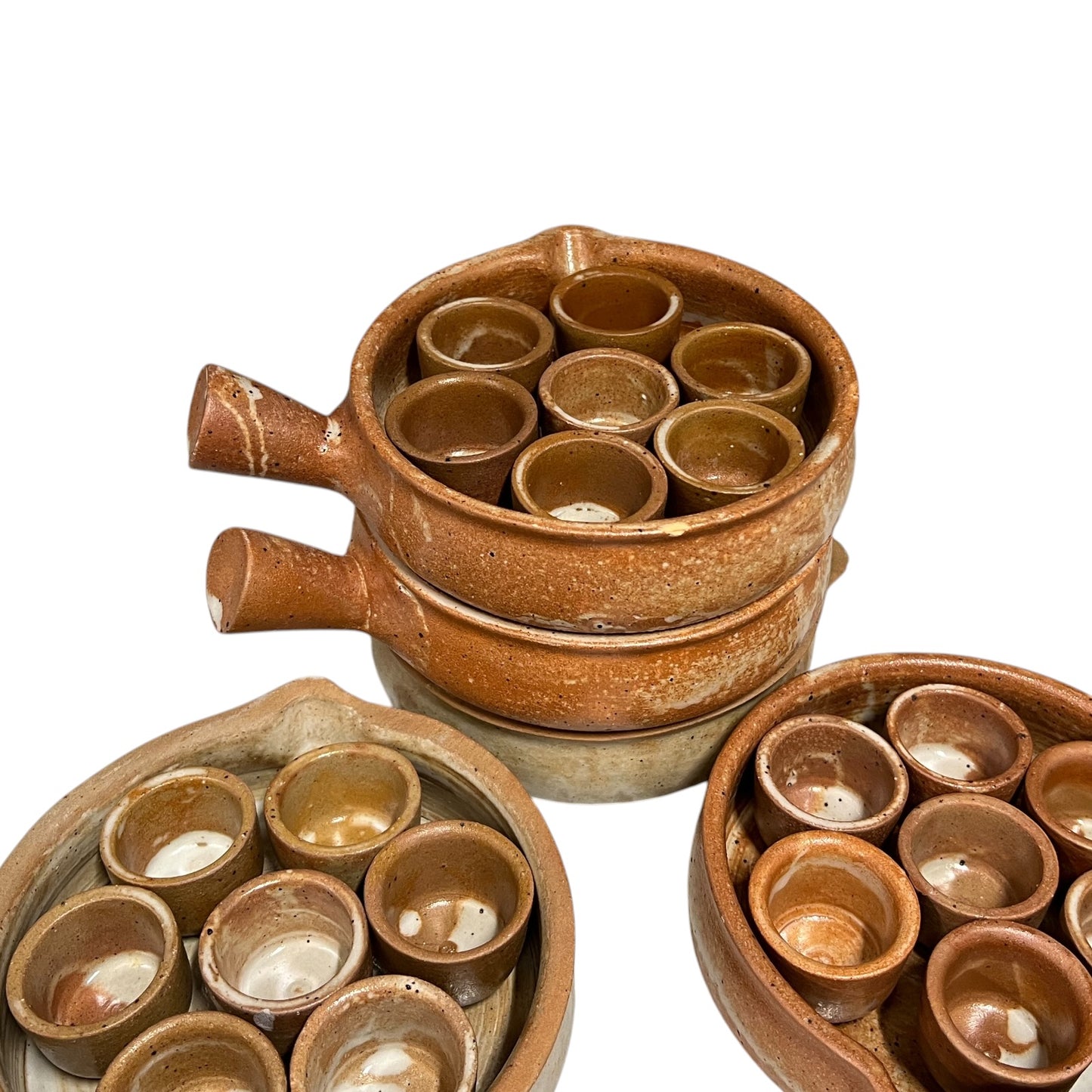 A set of rustic brown ceramic candle holders with multiple small cup-like compartments, shown on a plain white background.