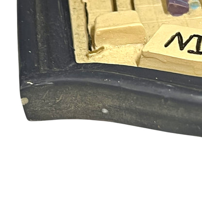 Close-up of a vintage bathroom door sign on a white background