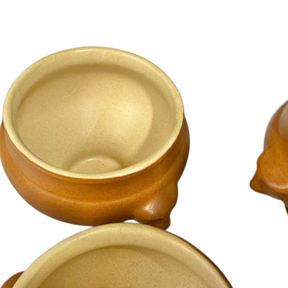 light brown ceramic French soup bowls with lions head handles on a white background 