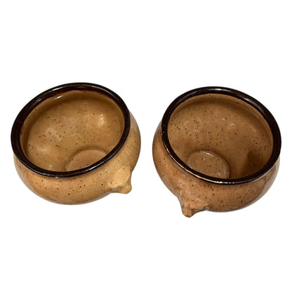 Two French soup bowls with lions head handles on a white background