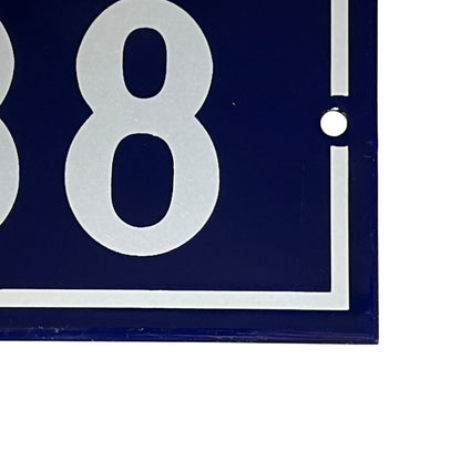 close up of a French vintage blue and white door number 88 on a white background 