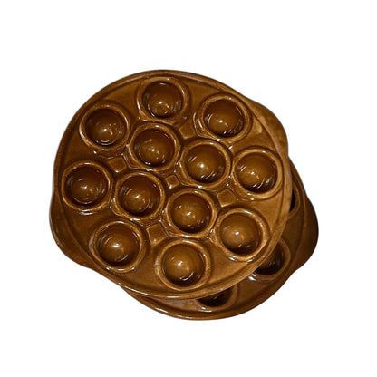 A pair of brown French vintage ceramic escargot plates, each featuring 12 holes and side handles, perfect for French recipes or adding charm to a farmhouse country kitchen, displayed on a white background.