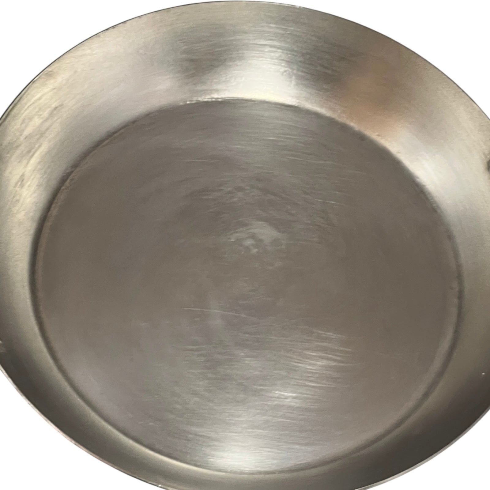 close up of French copper round gratin pan with brass handles and tin lining on a white background