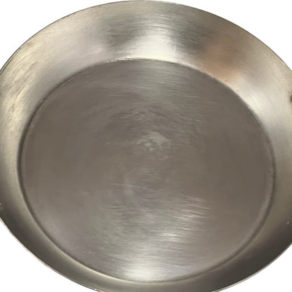 close up of French copper round gratin pan with brass handles and tin lining on a white background