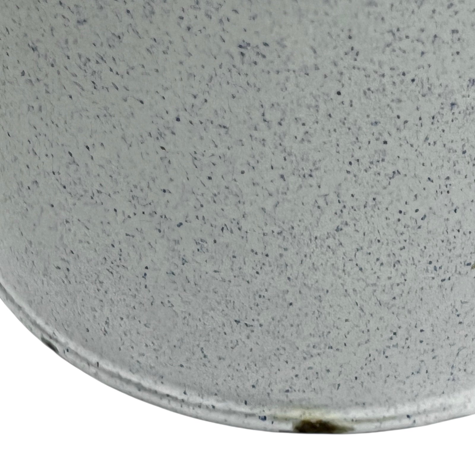 Close-up of a white and blue speckled material surface of a vintage planter