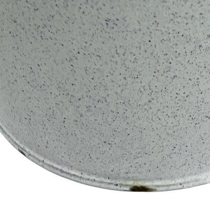 Close-up of a white and blue speckled material surface of a vintage planter