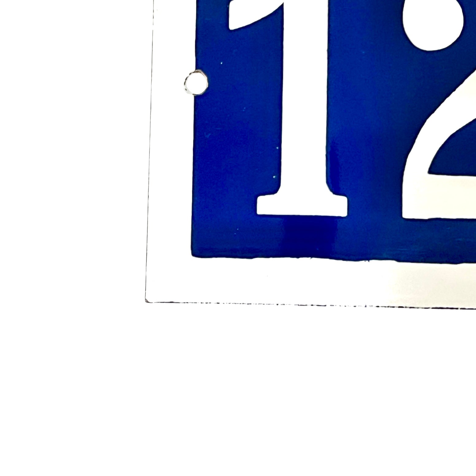 Close-up of a blue and white number  on a white background