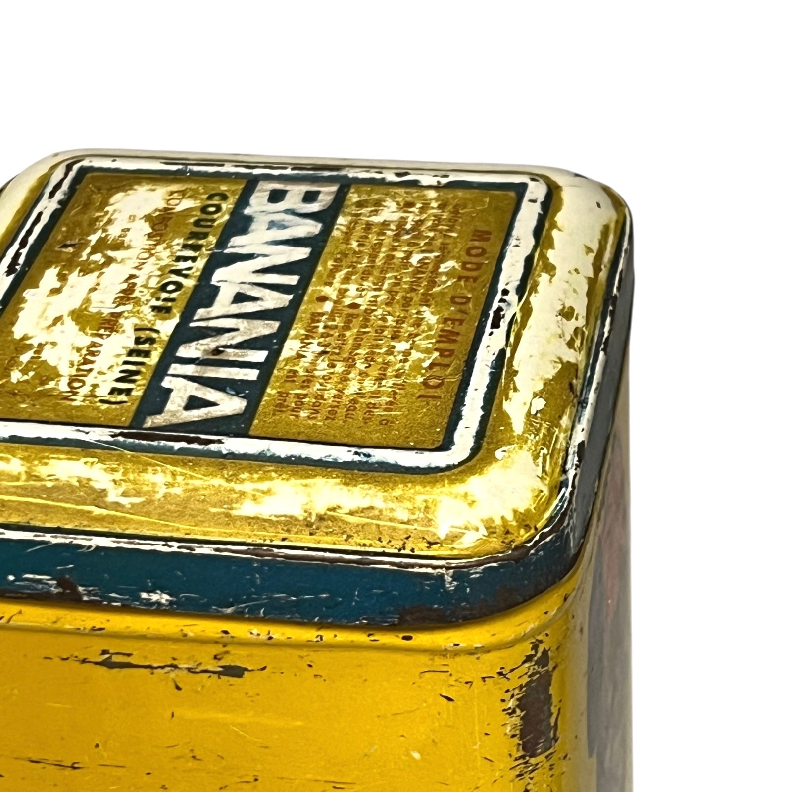 Vintage tin can with a colourful design featuring a face and 'Banania' branding on a white background.