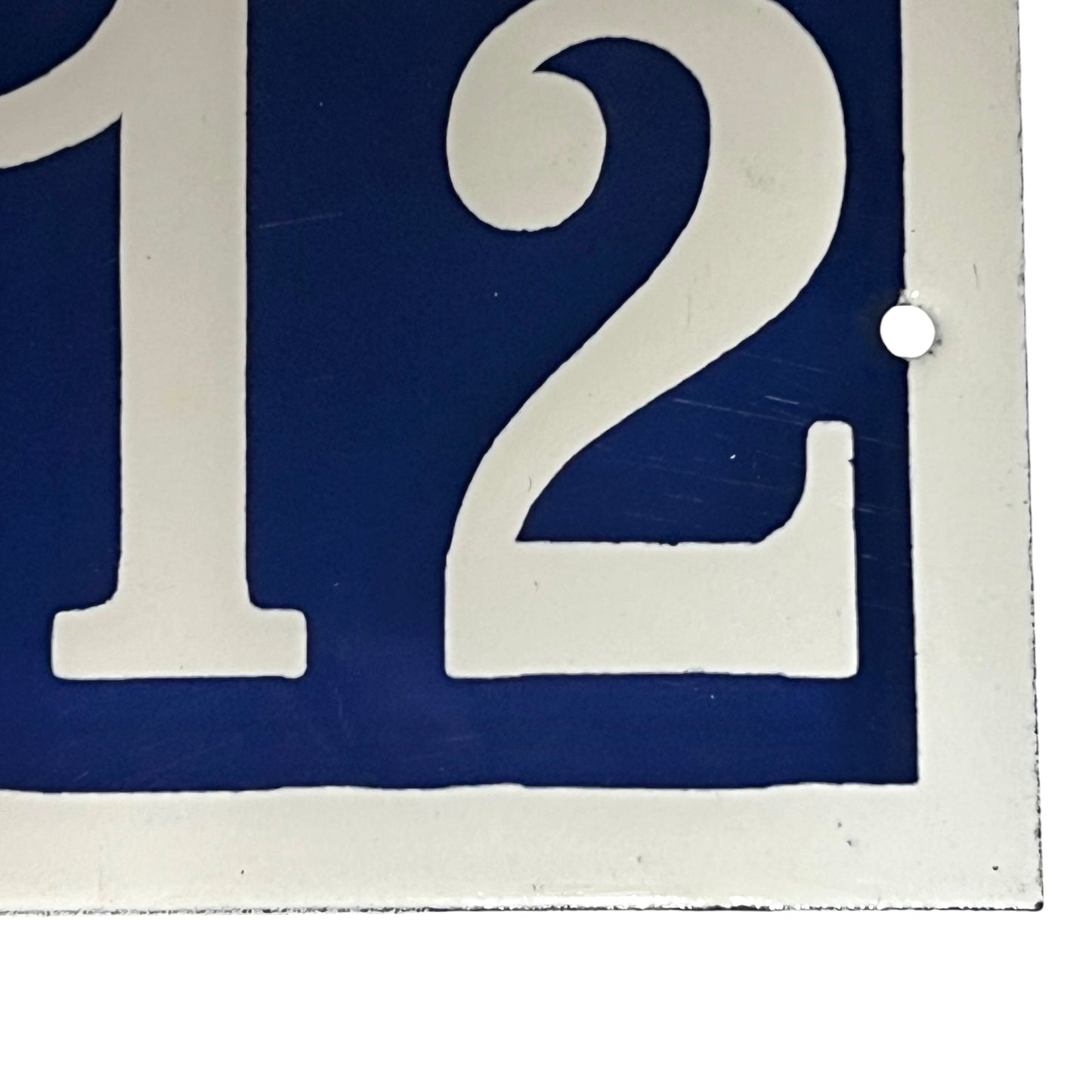 Close up of a French door number on a white background