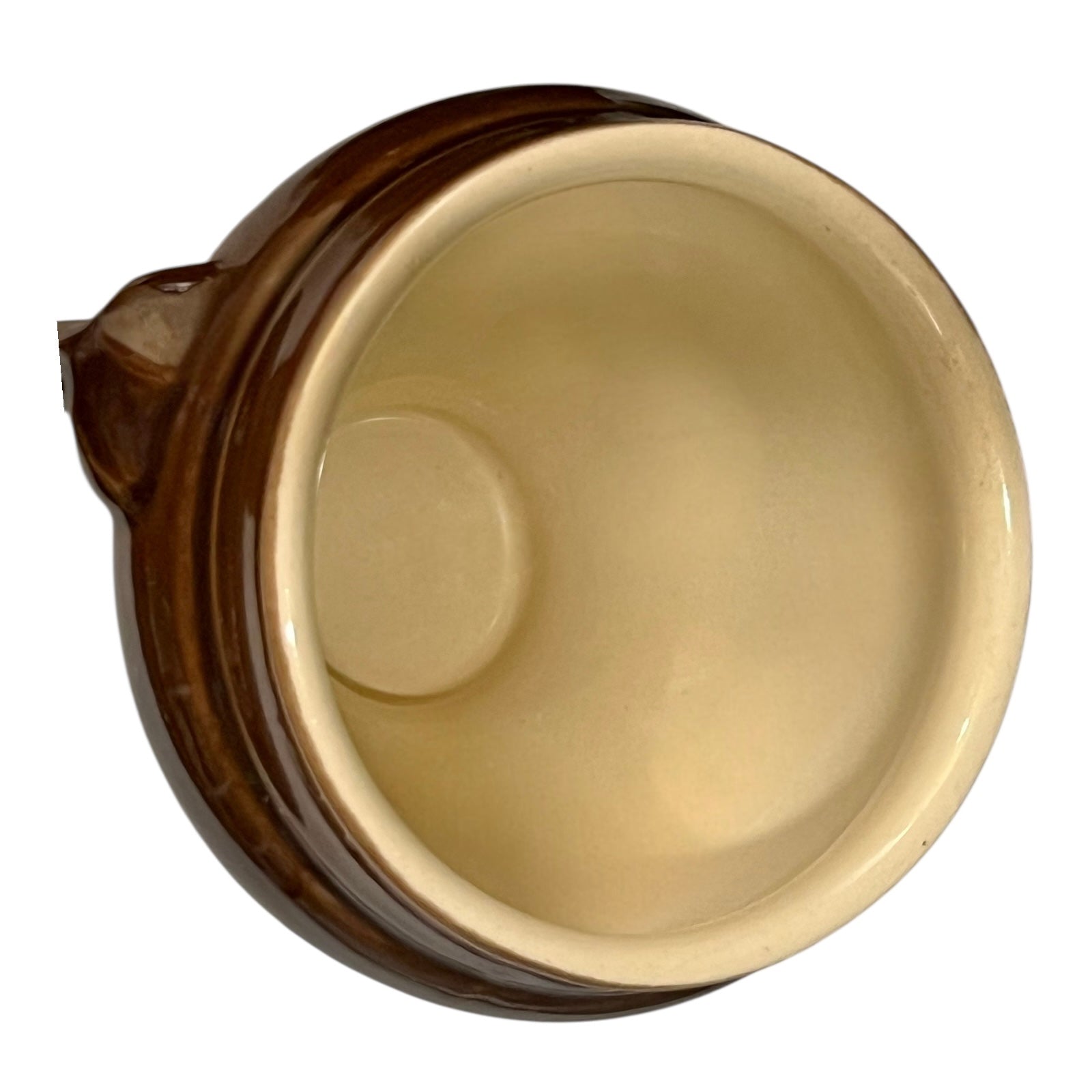 Brown ceramic bowl with decorative lion head handles on a white background