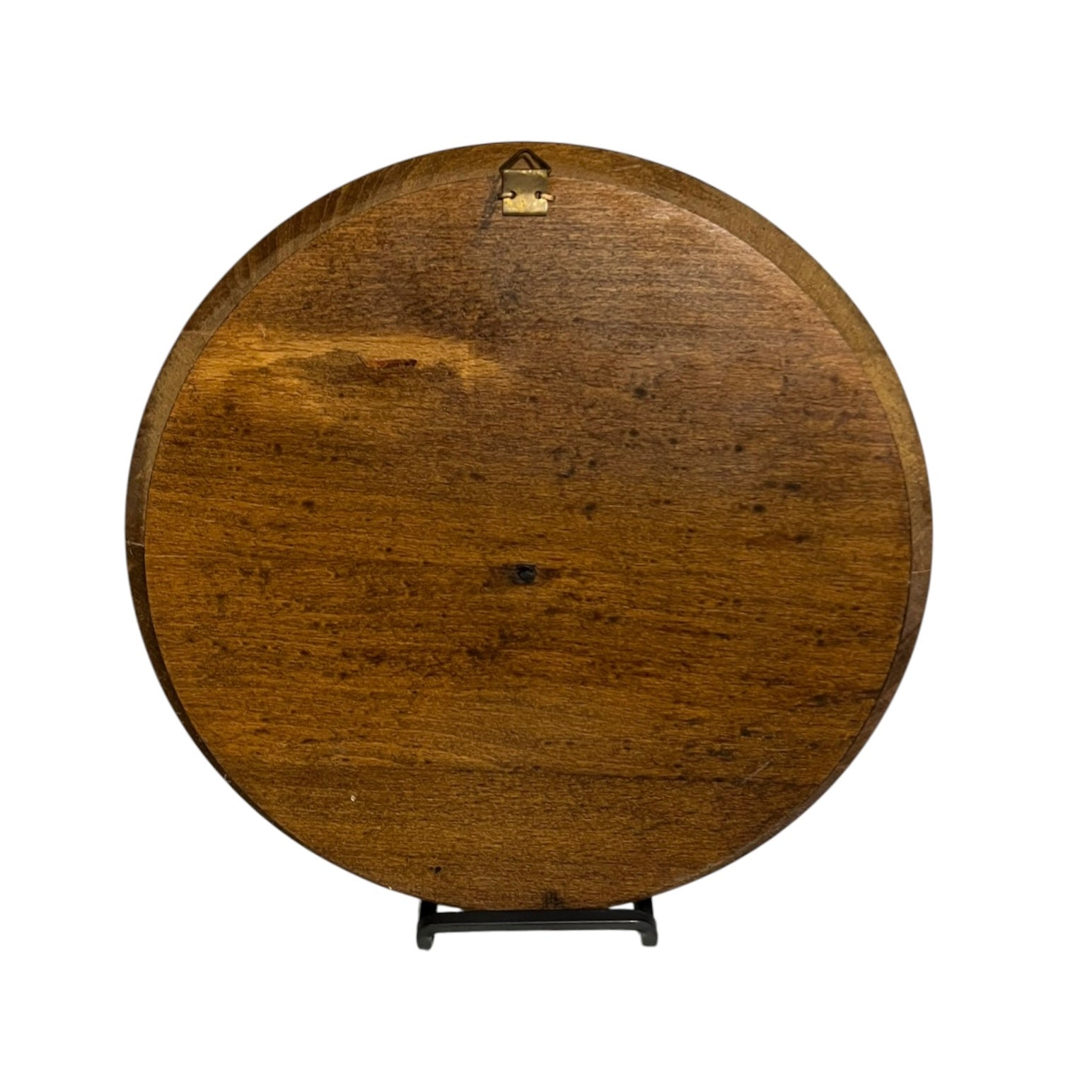 close up of a wooden decorative round plaque on a white background 