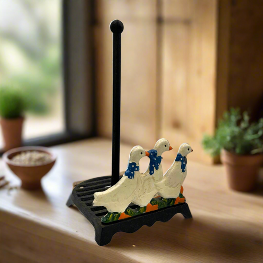Decorative paper towel holder with goose design on a wooden surface.