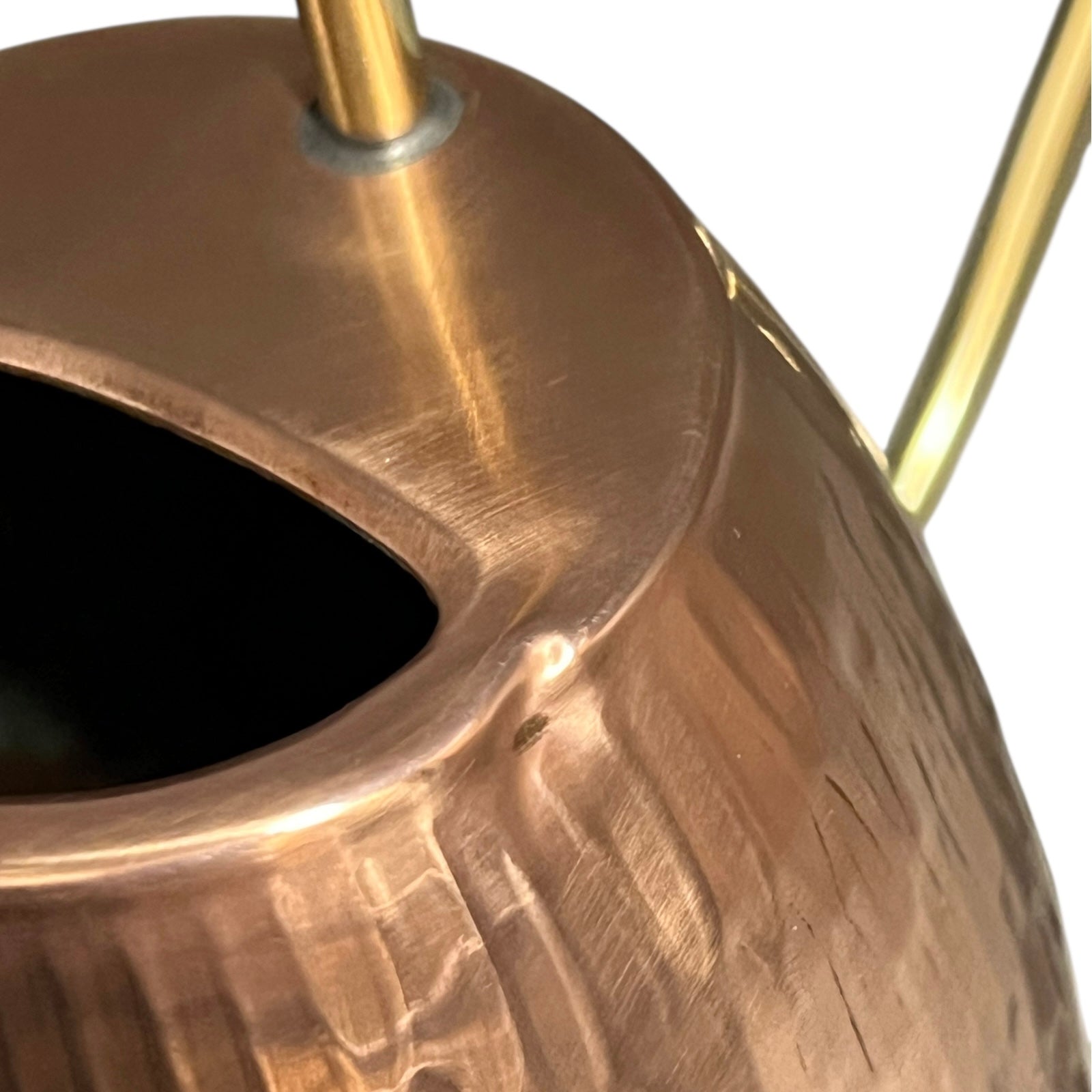 Close up of copper and brass watering can on a white background