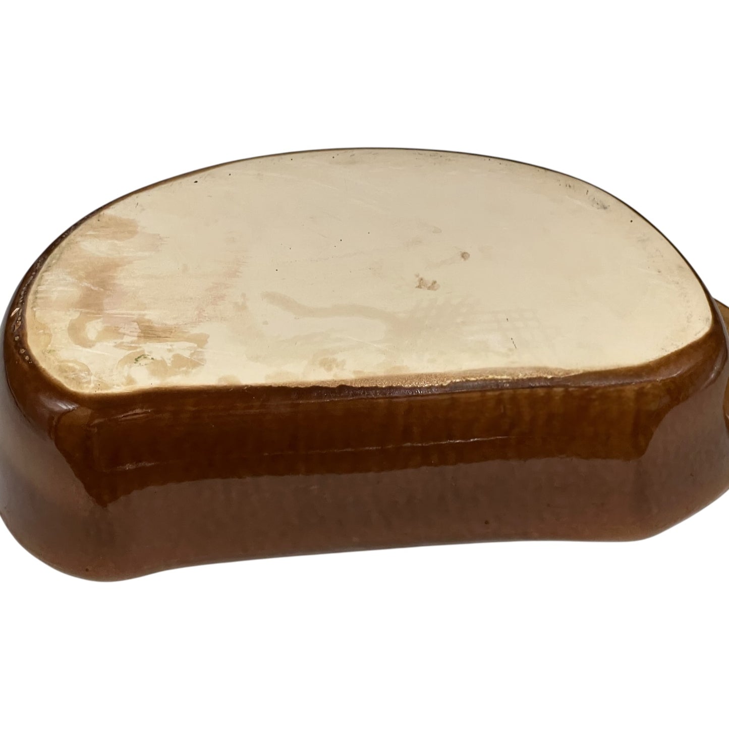 Close up of a rabbit shaped casserole dish on a white background