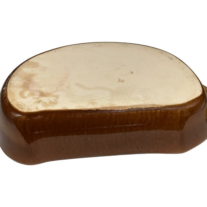 Close up of a rabbit shaped casserole dish on a white background