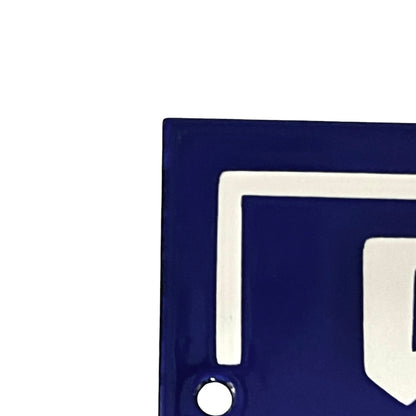 Close up of a French blue and white door number on a white background 
