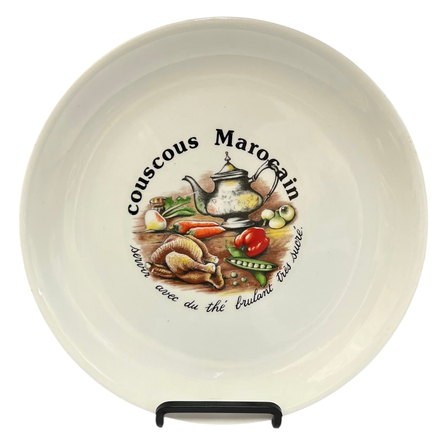 Ceramic plate with decorative design and text on a white background